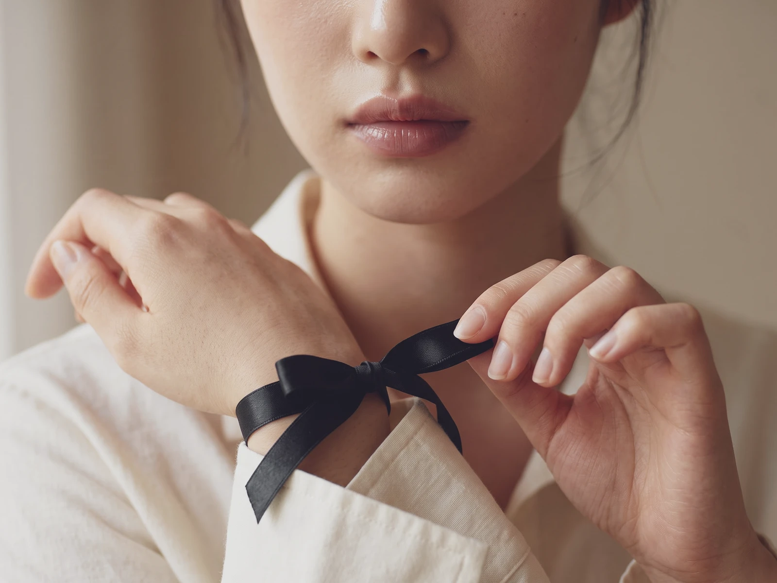 스몰 패션 리본 디테일, 손목에 묶은 블랙 새틴 리본 클로즈업